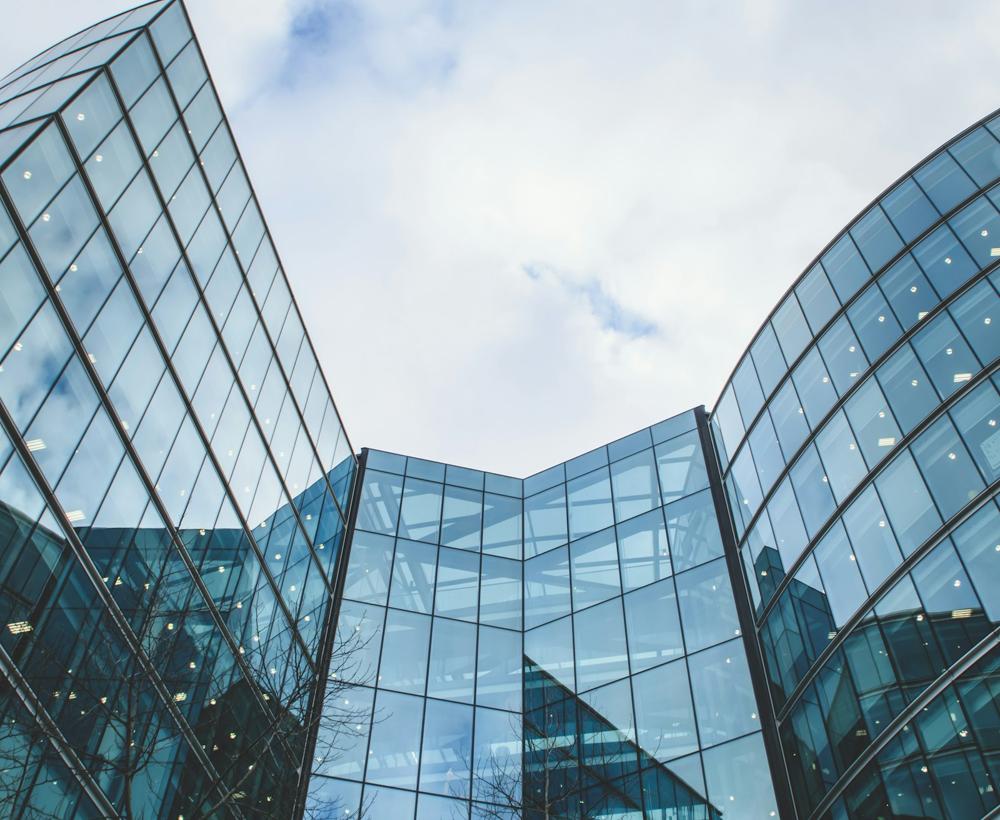 Modern glass commercial office towers under a clear sky