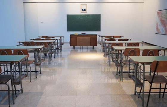 Clean, organized classroom with desks and a polished floor
